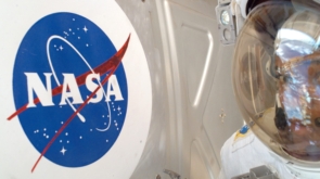 ISS014-E-09810 (14 Dec. 2006) --- Astronaut Robert L. Curbeam Jr., STS-116 mission specialist, meets the NASA logo up close during the Dec. 14 space walk to perform ISS work, which he shared with European Space Agency astronaut Christer Fuglesang.
